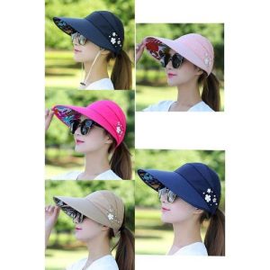 Collection of wide brim sun hats in navy, pink, bright pink, and beige with floral accents.