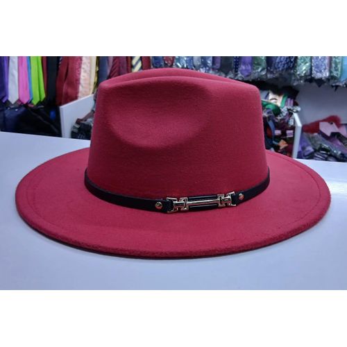 Red wide‑brim fedora hat with pinched crown and black band featuring metallic buckle detail.