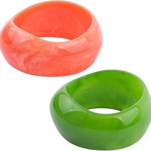 Glossy chunky acrylic bangles in bright red and vivid green, intertwined together.