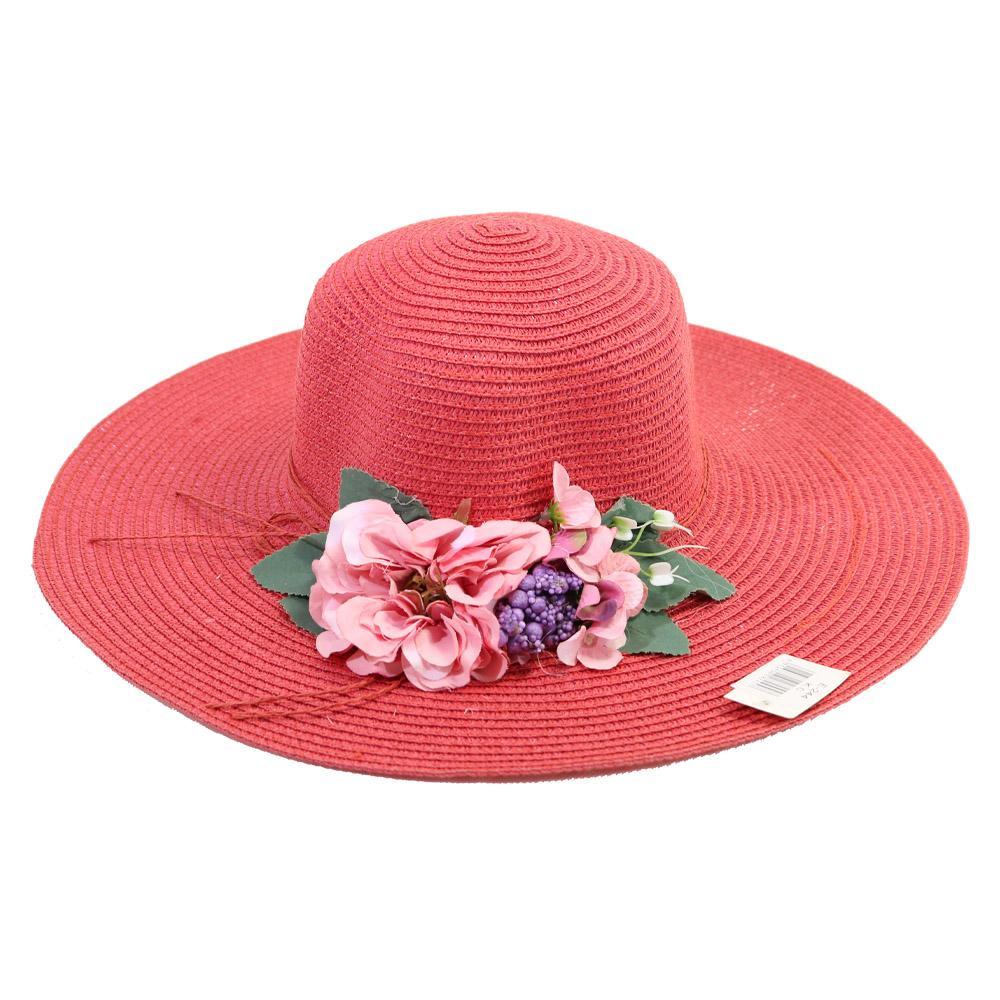Bright pink wide‑brim woven sun hat with floral decorations including blossoms, purple clusters, and green leaves.