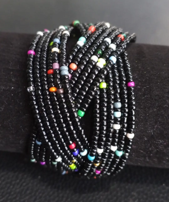 Beaded cuff wrap bracelet with black base and multicolor bead accents.