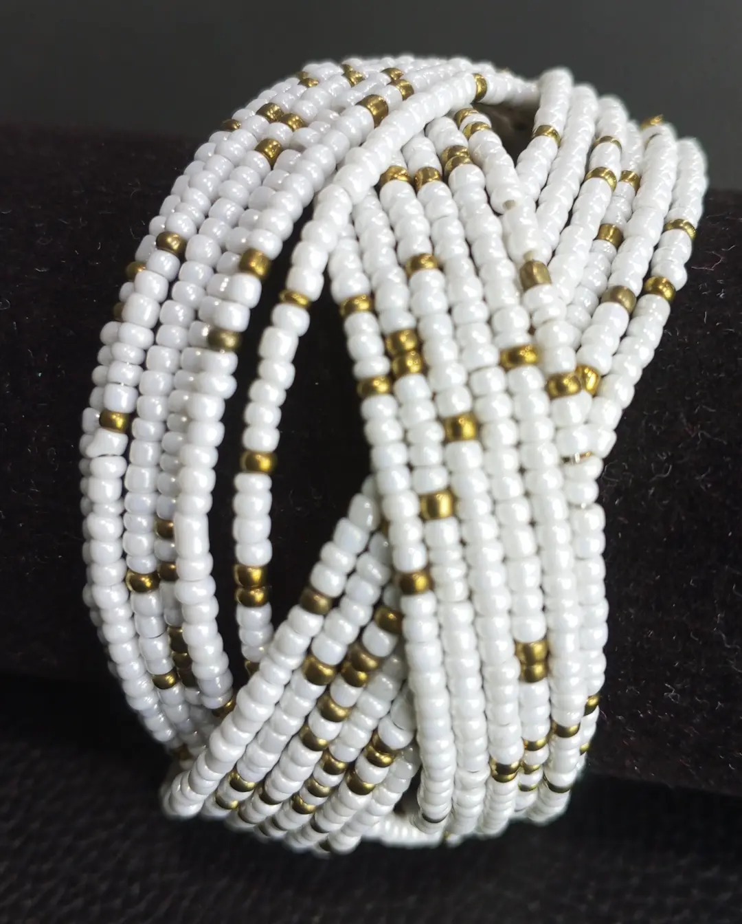 Beaded cuff wrap bracelet in white beads with gold accents.