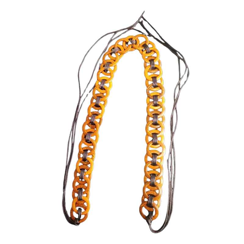 Bohemian African belt with orange wooden rings linked by cords.