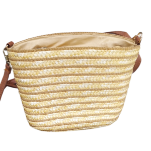 Summer sling bag in woven straw design with leather strap