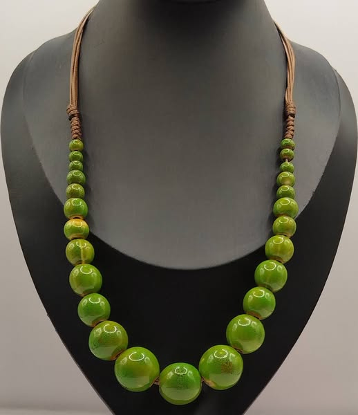 Bohemian ceramic bead necklace with handcrafted green ceramic beads in natural tones.