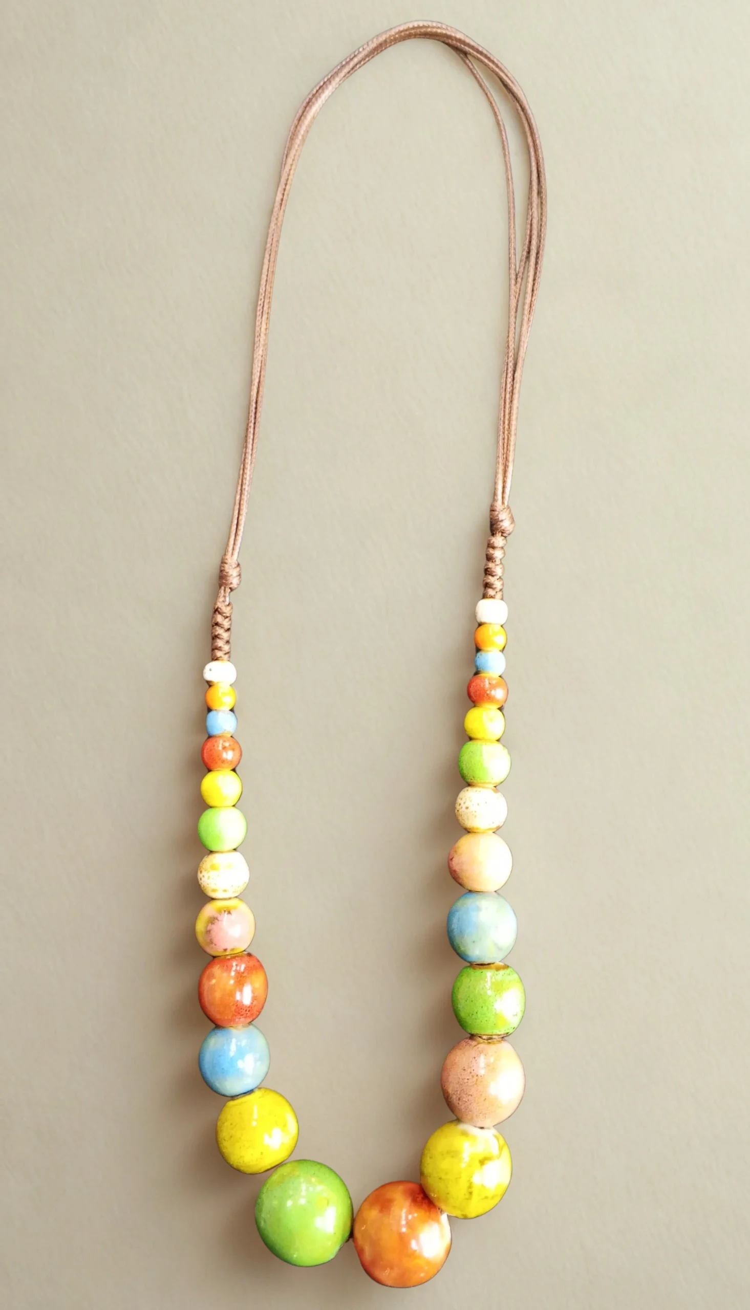 Bohemian ceramic bead necklace featuring mixed-color ceramic beads in playful arrangement.
