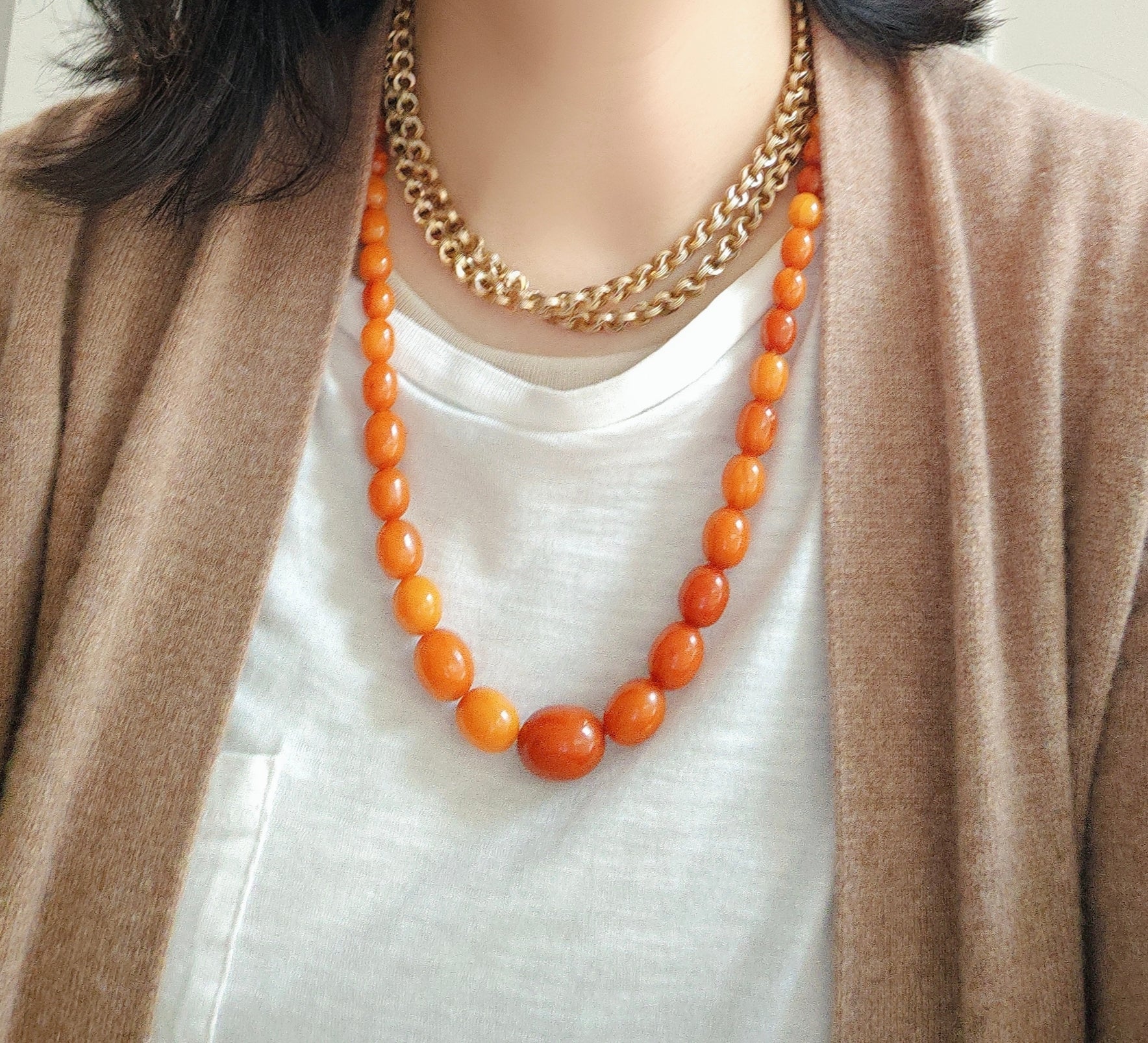 Bohemian ceramic bead necklace with bold orange ceramic beads and artisanal finish.