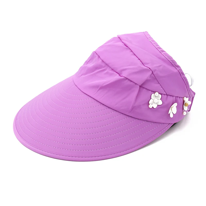 Purple sun visor hat with wide brim and decorative white flower and butterfly accents.