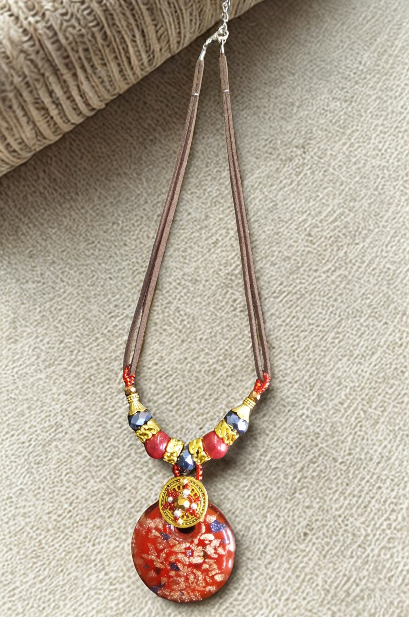 Handmade African necklace with bold red beads in traditional design.