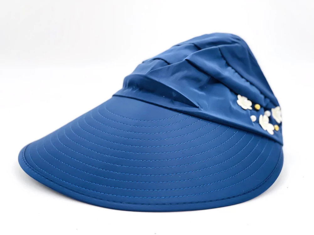Blue sun visor hat with wide brim and decorative white floral embellishments.