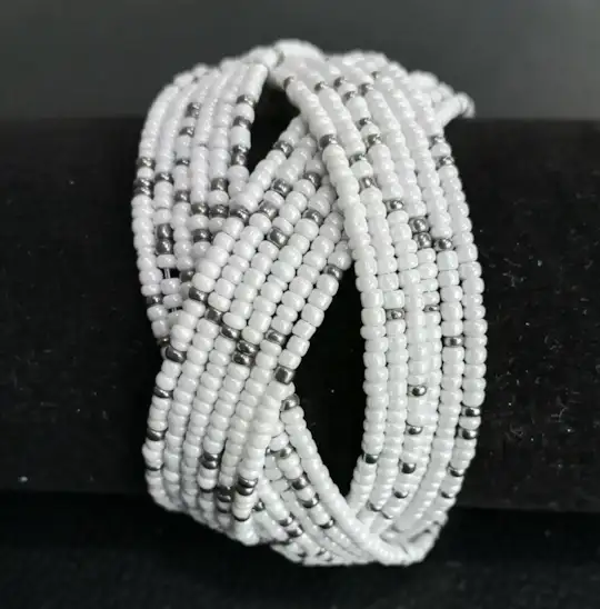 Beaded cuff wrap bracelet in white beads with silver accents.
