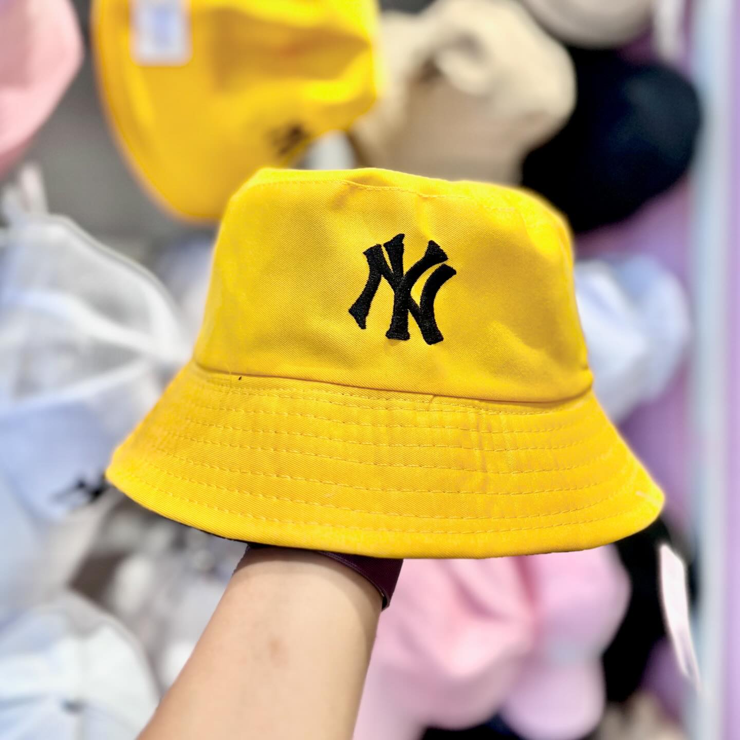 Yellow Yankees bucket hat with black embroidered logo.