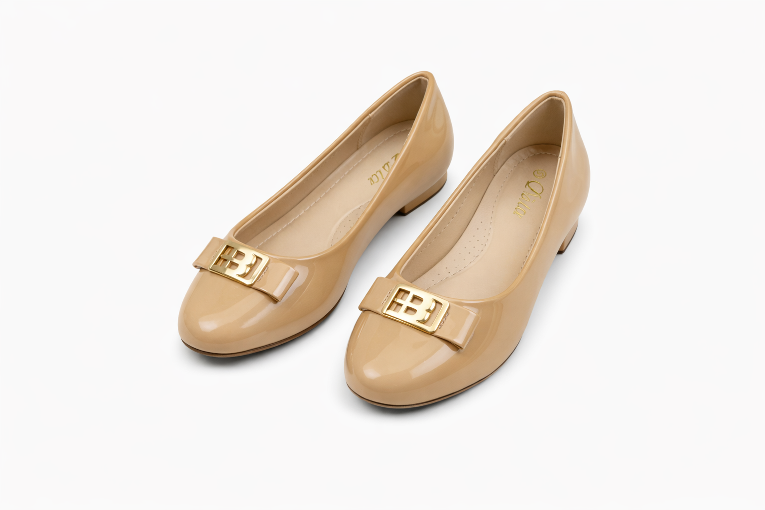 Beige patent leather low‑heeled shoes with bow and gold buckle accent.