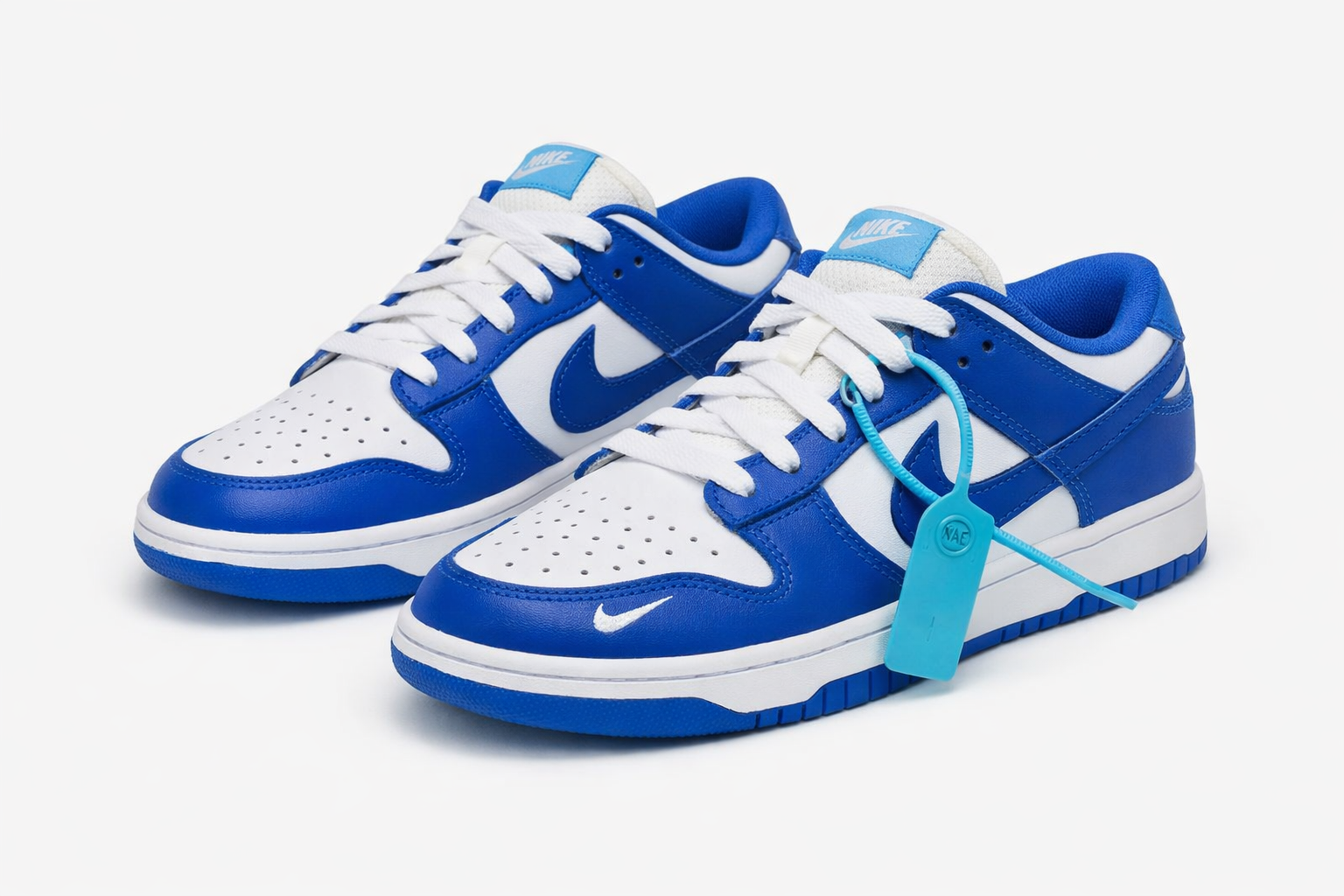 SB Dunk Low sneakers white leather base with royal blue overlays, blue swoosh, white laces, skateboarding shoes in Nairobi Kenya.