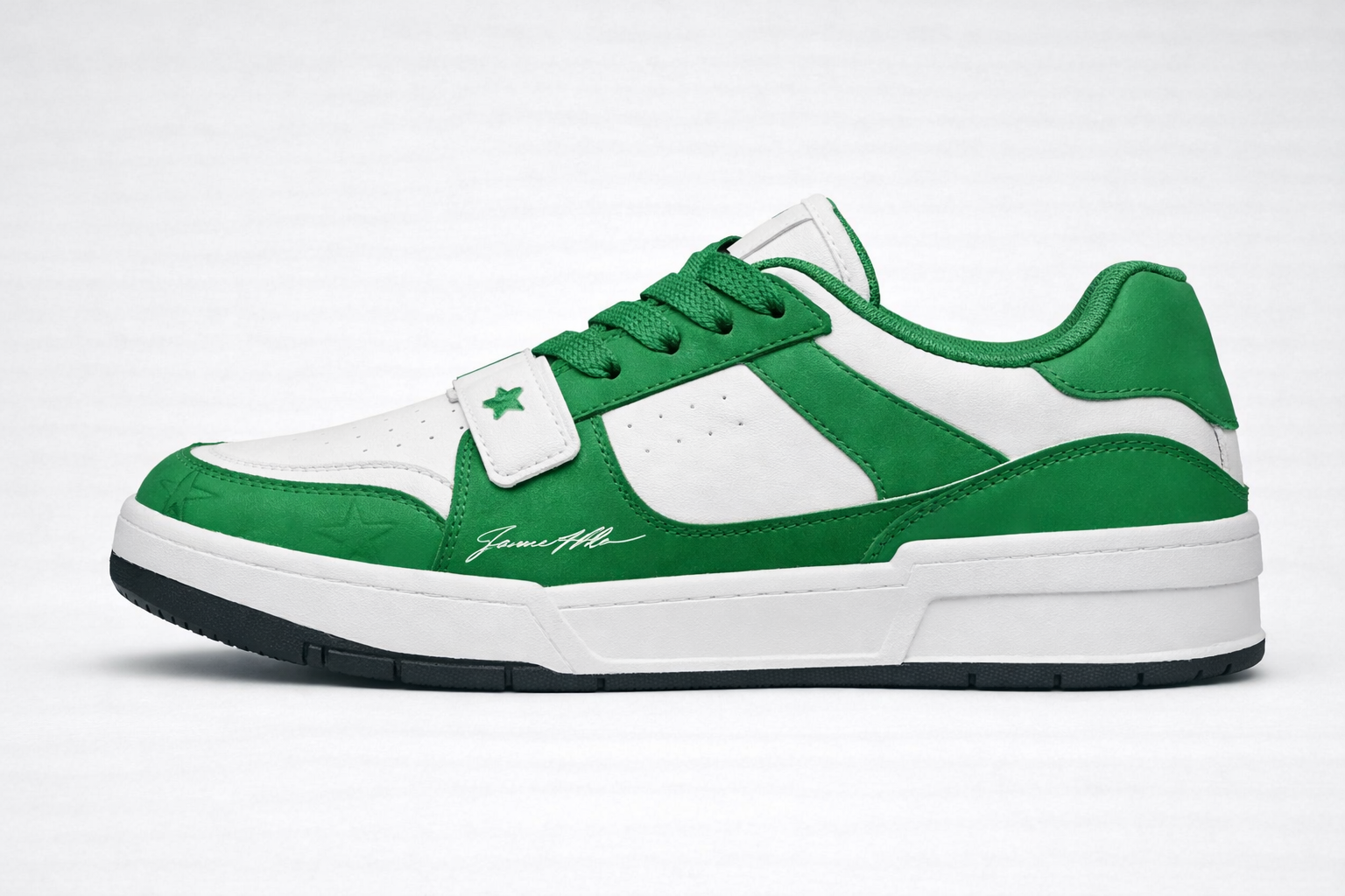 Green and white sneaker with suede overlays, green laces, and signature 'James Whitner' printed on side panel.