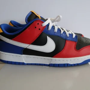 Nike Dunk Low Tennessee State University sneaker with red, blue, black, white, and yellow panels, white swoosh, white laces, and blue outsole Nairobi Kenya.