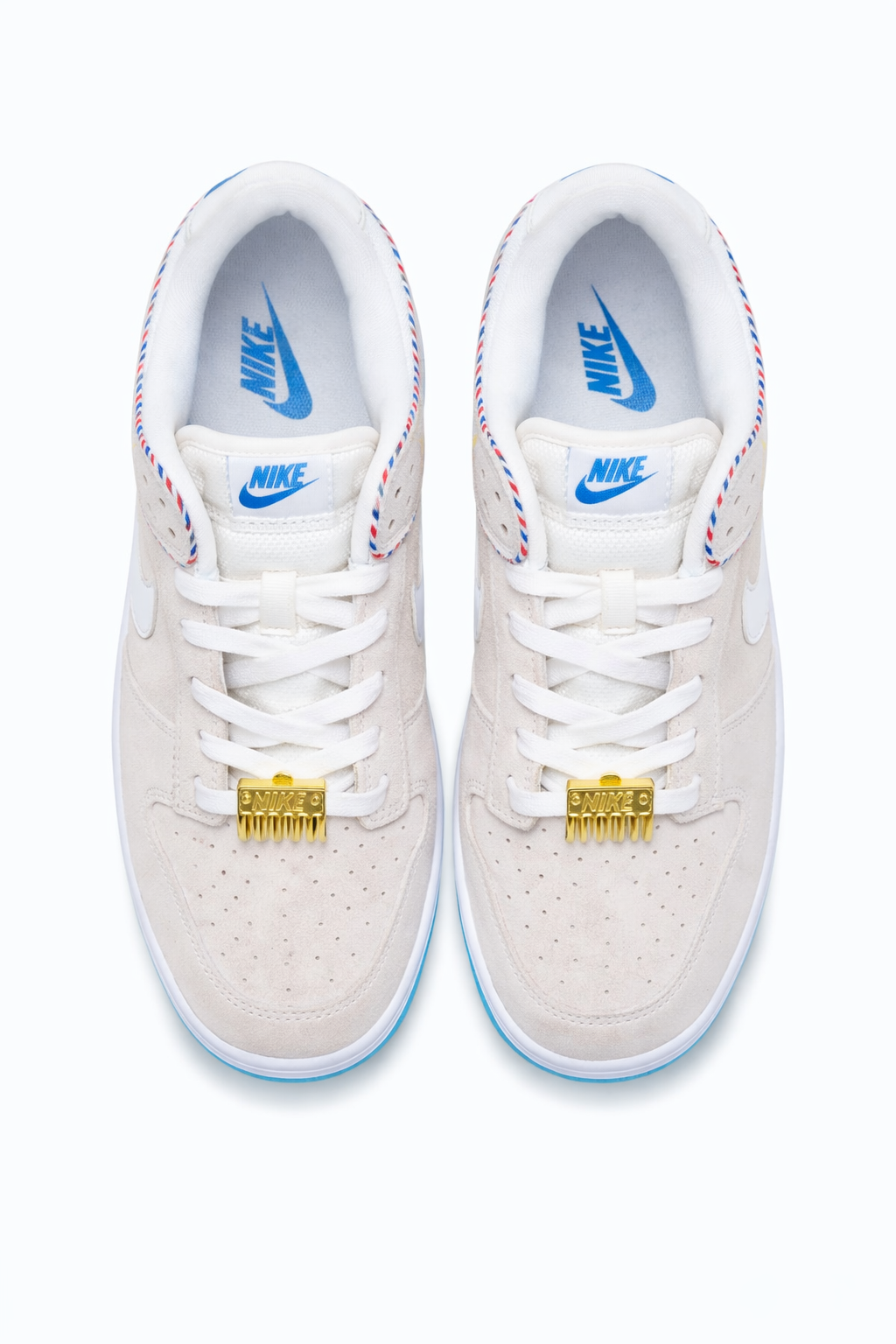 Nike Dunk Low SE Barber Shop Grey Sneakers Gold Lace Ornament Nairobi Kenya Nike Dunk Low SE Barber Shop Grey sneakers top view with off‑white upper, blue accents, gold lace ornament shaped like hair comb, and striped collar trim Nairobi Kenya.