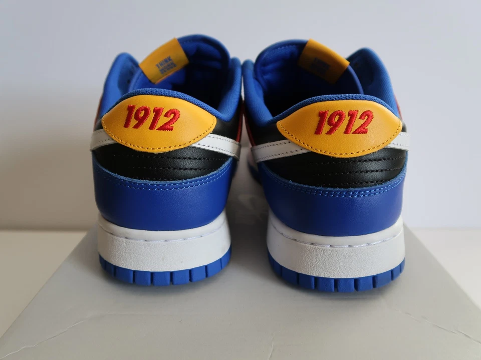 Nike Dunk Low Tennessee State University Sneakers with 1912 Heel Embroidery Nairobi Kenya Nike Dunk Low Tennessee State University sneakers back view with blue, black, white, and yellow panels, red 1912 embroidery on heel tab, and white midsole Nairobi Kenya