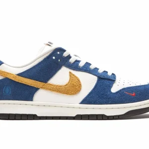 Nike x Kasina Dunk Low ’80s Bus sneaker with blue suede overlays, white leather panels, textured yellow swoosh, and mini orange swoosh near toe Nairobi Kenya.