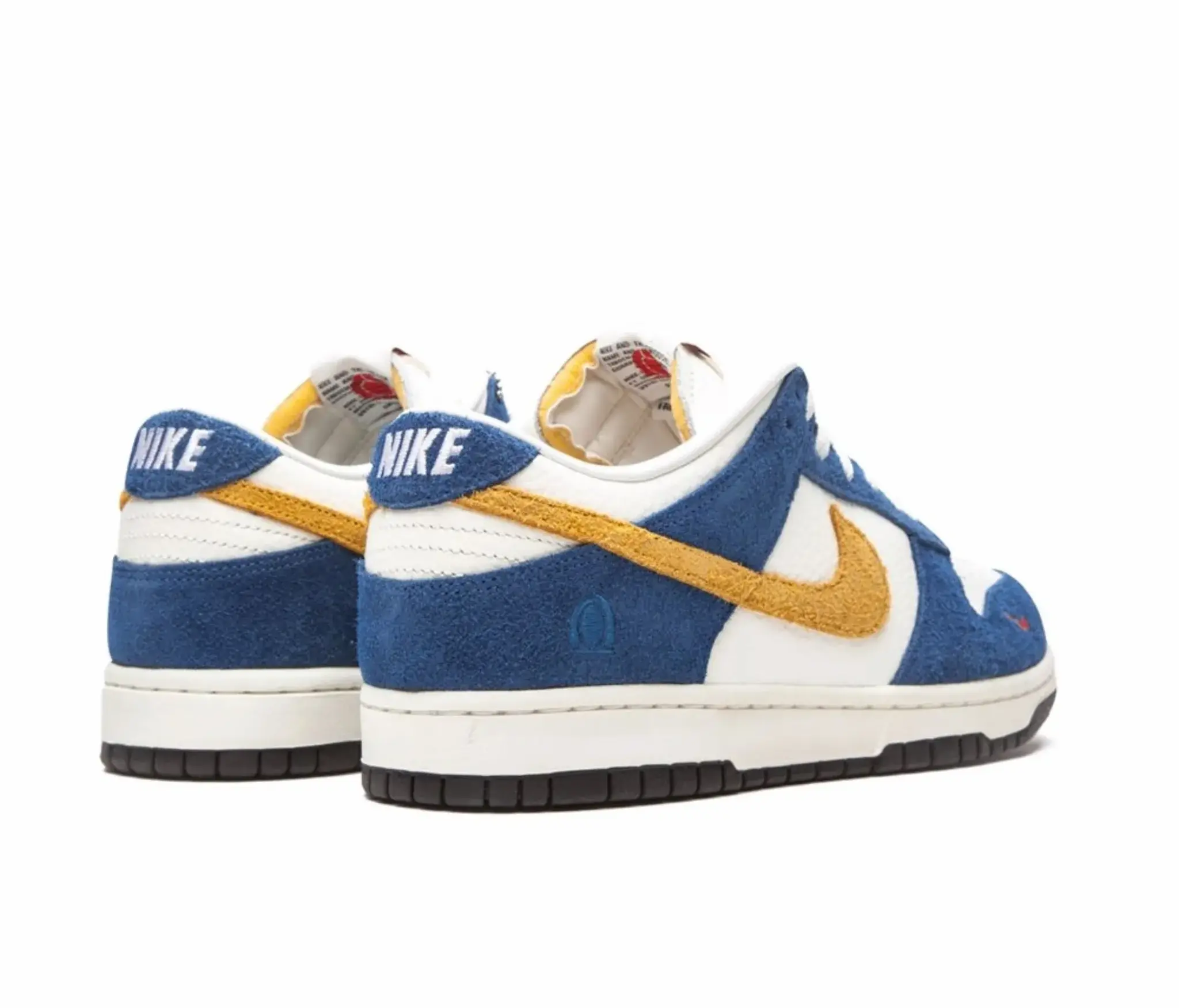 Nike x Kasina Dunk Low ’80s Bus Sneakers Heel Branding Blue Yellow Nairobi Kenya Nike x Kasina Dunk Low ’80s Bus sneakers back view with blue suede heel tab, white NIKE embroidery, mustard yellow swoosh and heel accents, white midsole, and black outsole Nairobi Kenya.