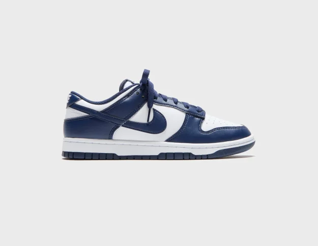 Nike Dunk Low Retro sneakers with white leather base, navy blue overlays, navy swoosh, navy laces, and white midsole Nairobi Kenya.
