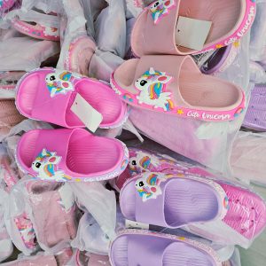 Cover image showing colorful kids slides in Nairobi Kenya. Variants include pink, purple, and light pink rubber sandals with unicorn cartoon strap, rainbow mane and tail, and 'Cute Unicorn' branding on the sides.