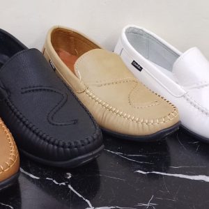 Cover image showing four pairs of casual loafers in Nairobi Kenya. Variants include brown, black, beige, and white leather slip‑on shoes with stitched detailing and moccasin‑style design, displayed on a black marble surface.